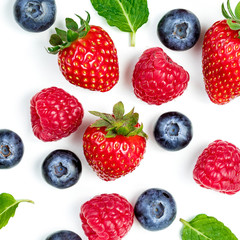 Berry Pattern. Fresh berries isolated on white background, top view. Strawberry, Raspberry, Blueberry and Mint leaf, flat lay.