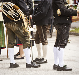 Brass band musicians in Bavarian costume attending a traditional parade