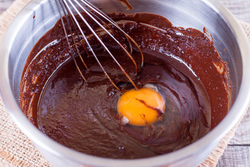 Mixed yolk eggs and chocolate for baking cake or bake.