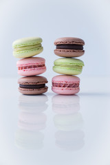 Colorful macaroons stacked on white background