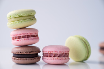Colorful macaroons stacked on white background