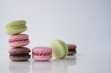 Colorful macaroons stacked on white background