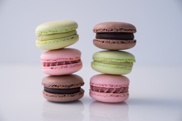 Colorful macaroons stacked on white background
