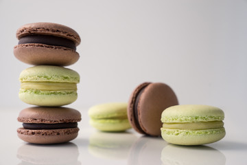 Colorful macaroons stacked on white background