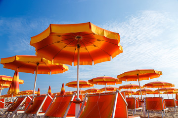 Beautiful orange umbrellas on the beach in Emilia-Romagna, Rimini, Italy. 