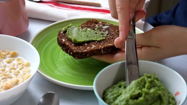 Woman Spreding her Bread with Avocado