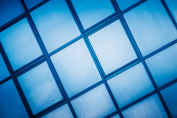 full frame of modern glass building,blue toned.