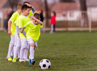 Young children players football match on soccer field