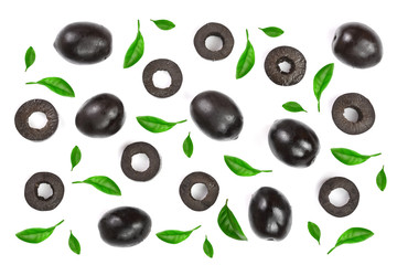 whole and sliced black olives decorated with leaves isolated on white background. Top view. Flat lay pattern