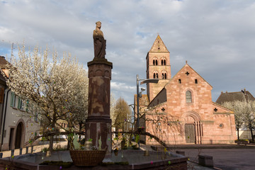 Fototapeta na wymiar Sainte Richarde, fontaine en grès rose, et ses décorations de Pâques, place de l’église de Sigolsheim, Kaysersberg vignoble.