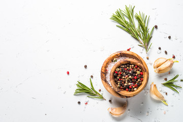Spices and herbs over white stone table top view. 