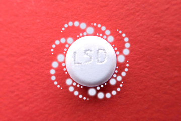 Tablet LSD on red pattern light psychedelic