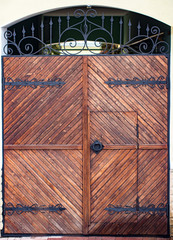 Old Wooden gate with metal decoration close up