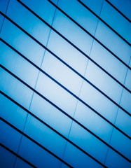 Fototapeta premium full frame of modern glass building,blue toned.