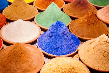 Color coloring dye powder piles in Indian market blue, orange, yellow , ochre