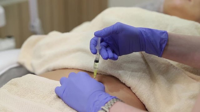 Woman doing shot in stomach