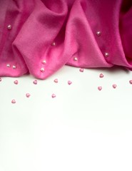 Isolated pink silk scarf surrounded with white and pink hearts