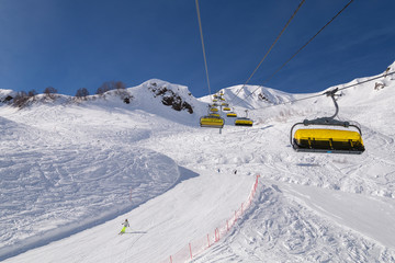 ski liftYellow chair lifts against the beautiful mountains.