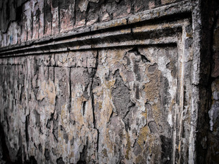 Ruins with stucco molding on old cracked wall