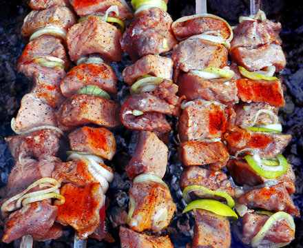 Beef kebabs on a open air. Fresh hot grilled beef meat with onion. Cooking meal on hot coals at summer