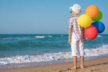 One happy little boy playing on the beach at the day time.
