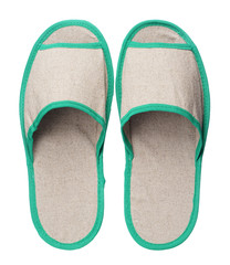Green hotel slippers isolated on white background. Close up, high resolution