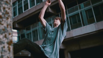 Slow motion parkour running athlete - Powered by Adobe