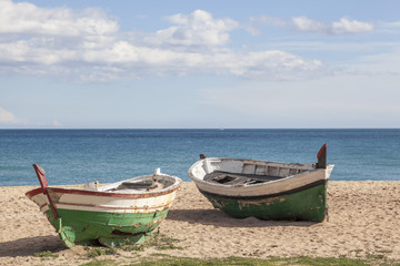 Fototapeta na wymiar Mediterranean beach and two fishing boats.