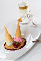 almond and strawberry ice cream balls in waffles, served with fresh mint leaves, raspberries and a cup of cappuccino with brown sugar, restaurant, food menu photo