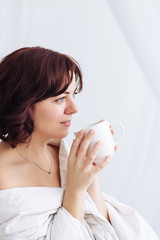 portrait Caucasian girl blanket bare shoulders coffee