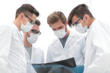 male doctors looking attentively at x-ray