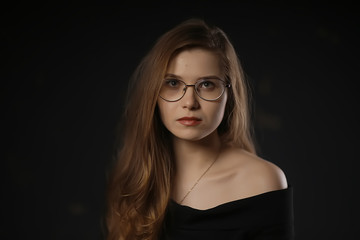 serious young woman with glasses / businesswoman serious look in glasses. concept vision business, youth
