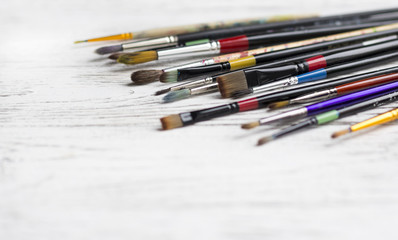 Fototapeta premium Artist brushes on white wooden background