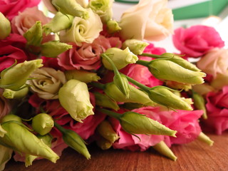 Bouquet of pink eustoma on a wooden background. Flower shop