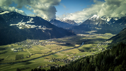 Fototapeta na wymiar Aerial view on beautiful, mountains landscape and the city Innsbruck is among them. Sunny, spring day. View from drone.