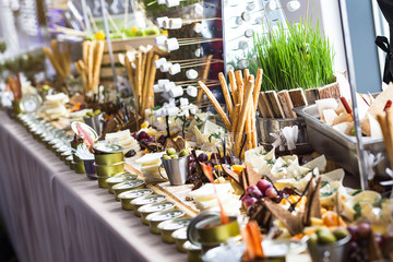 holiday buffet table served by different canape, sandwiches, snacks ready for eating in restaurant
