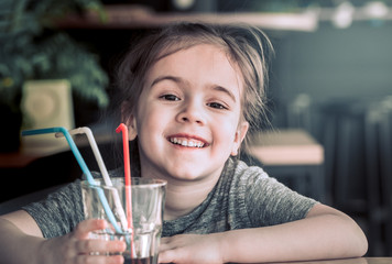 a child drinks a drink from a straw