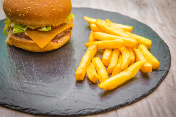 Hamburger with fries on blackboard