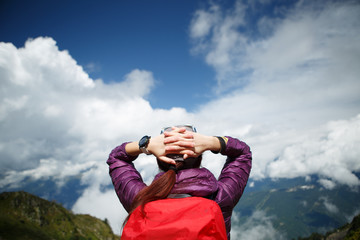 Photo of woman with hands behind head