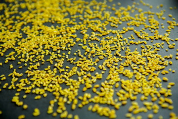 Groats bulgur placer, a pile on a black background is lined in the form of a pattern. The product...