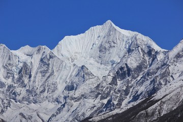 Fototapeta na wymiar Snow covered mountain Gangchenpo in spring. Langtang valley, Nepal.