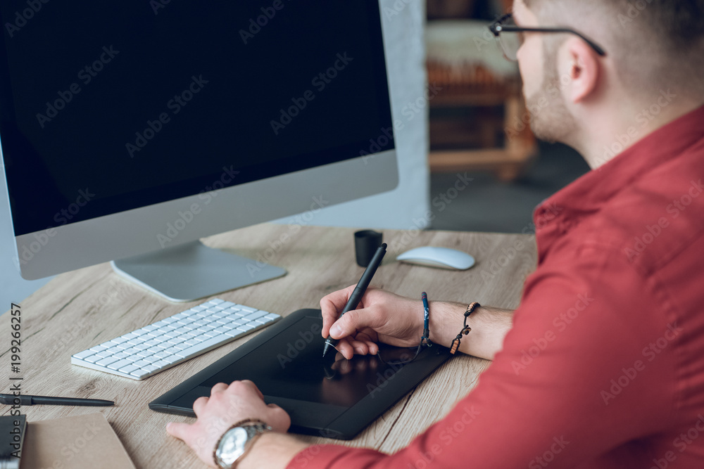 Poster bearded man drawing with graphic tablet by table with computer