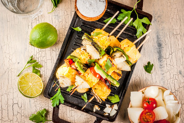 Vegan diet food, Grilled cheese and vegetables kebab, indian style Paneer Tikka, with white sauce and lime, on light concrete background, copy space top view