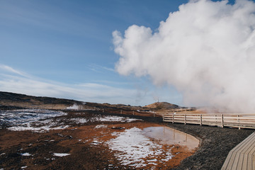 majestic view of wooden walkway and geothermal hot springs in iceland, Gunnuhver Hot Springs, reykjanes