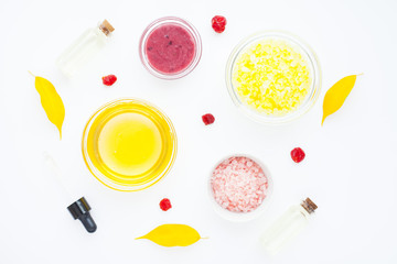Natural herbal skin care products. Top view ingredients honey, sea salt, berries, oil and soap on the white background. Medical care, spa, beauty, health concept. 