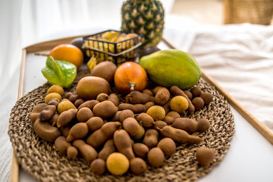 tropical fruits on the tray on the bed