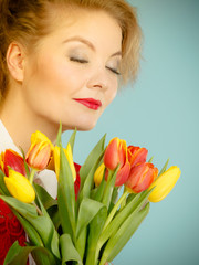 Pretty woman with red yellow tulips bunch