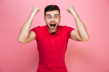 Fototapeta premium Portrait of a happy young man celebrating success