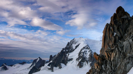 red granite rock needles with a great view of Mont Blanc in the background in the French Alps