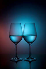 two glasses for wine on a blue background